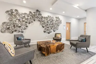 a living room with chairs and a table and a balloon at Palatial 1BR with Rooftop Pool in Philadelphia