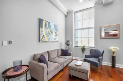 a living room with a couch and two chairs at Sleek 1BR with Rooftop Amenities in Philadelphia