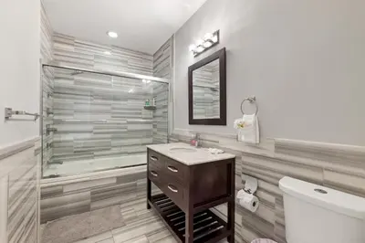 a bathroom with a shower and a sink and a toilet at Sleek 1BR with Rooftop Amenities in Philadelphia