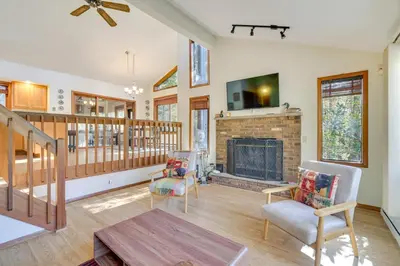 a living room with a fireplace and a staircase at Near Water Parks Pet-Friendly Tobyhanna Getaway! in Tobyhanna