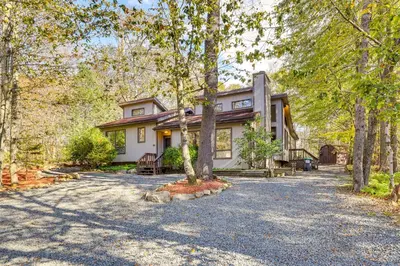 a home in the woods with a driveway at Near Water Parks Pet-Friendly Tobyhanna Getaway! in Tobyhanna
