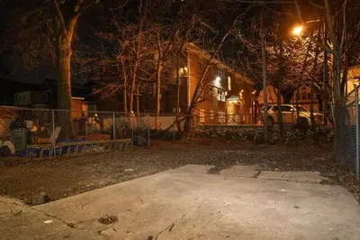 a yard at night with a fence and a car at Divine Villa and Resort -26 Grace Street Irvington NJ -EWR airport -Prudential - NJIT -Penn station in Irvington
