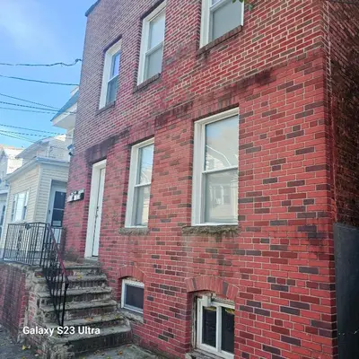a red brick building with stairs on the side of it at Divine Villa and Resort -26 Grace Street Irvington NJ -EWR airport -Prudential - NJIT -Penn station in Irvington