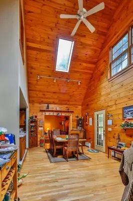 a living room with a ceiling fan and a dining room at The Old Tioga Inn Bed and Breakfast in Fairmount Springs