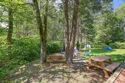 a picnic table and a bench in a park at Poconos Cabin Year Round Bliss in Greentown