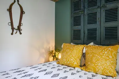 a bedroom with a bed with yellow and white pillows at Poconos Cabin Year Round Bliss in Greentown