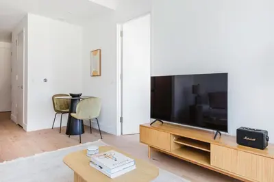 a living room with a large flat screen tv at Blueground Midtown West gym doorman wd NYC-1560 in New York