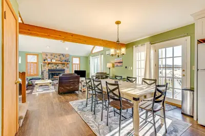 a dining room and living room with a table and chairs at Lakefront Cabin Kayaks, Paddle Boards and Fishing in Pocono Lake