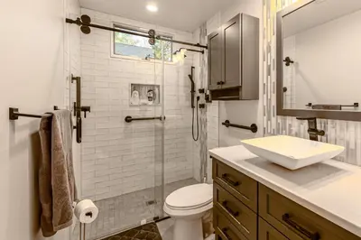 a bathroom with a toilet and a glass shower at Lakefront Cabin Kayaks, Paddle Boards and Fishing in Pocono Lake