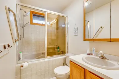 a bathroom with a toilet and a shower and a sink at Lakefront Cabin Kayaks, Paddle Boards and Fishing in Pocono Lake