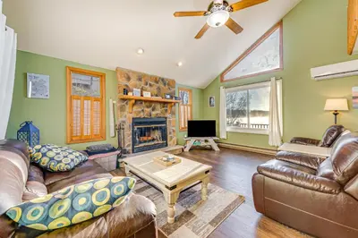 a living room with leather furniture and a fireplace at Lakefront Cabin Kayaks, Paddle Boards and Fishing in Pocono Lake