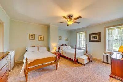 a bedroom with two beds and a ceiling fan at Walk to Creek Mount Joy Home with Peacocks On-Site! in Mount Joy