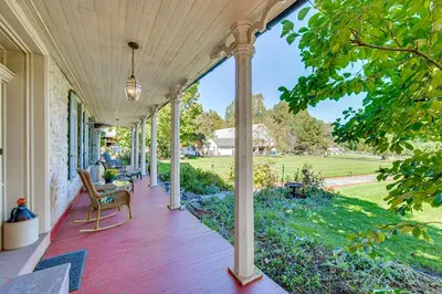a porch of a house with a wooden deck at Walk to Creek Mount Joy Home with Peacocks On-Site! in Mount Joy