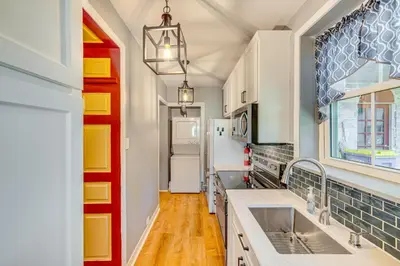 a kitchen with a sink and a refrigerator at Walk to Creek Mount Joy Home with Peacocks On-Site! in Mount Joy