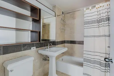 a bathroom with a sink and a toilet and a shower at Blueground Jersey City 1bd apartment NYC-1603 in New York
