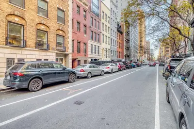 a row of cars parked on a city street at Blueground Jersey City 1bd apartment NYC-1603 in New York