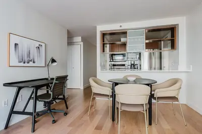 a dining room with a table and chairs at Blueground Jersey City 1bd apartment NYC-1603 in New York