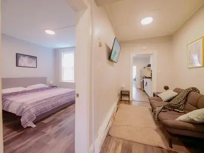 a bedroom with a bed and a couch at Serene Two-Bedroom Retreat - close to NYC in Jersey City