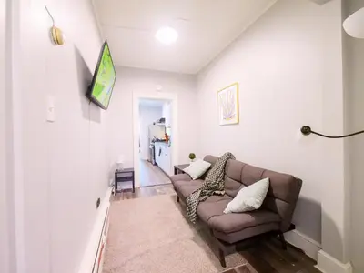 a living room with a couch and a table at Serene Two-Bedroom Retreat - close to NYC in Jersey City