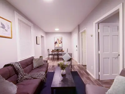 a living room with a couch and a table at Modern comfort-2BR haven mins to NYC in Jersey City