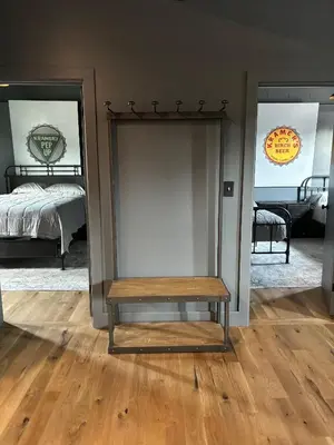 a room with a bench in front of a bedroom at the old soda factory in Mount Carmel
