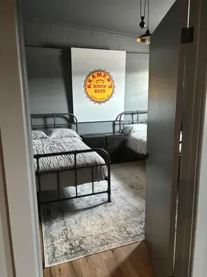 a room with two beds and a sign on the wall at the old soda factory in Mount Carmel