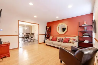 a living room with a couch and a table at Mountain View-Steam Shower-2 Tier Patio- King Bed in Northampton