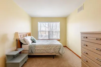 a bedroom with a bed and a window at Mountain View-Steam Shower-2 Tier Patio- King Bed in Northampton