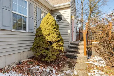 a house with a christmas tree in front of it at Mountain View-Steam Shower-2 Tier Patio- King Bed in Northampton