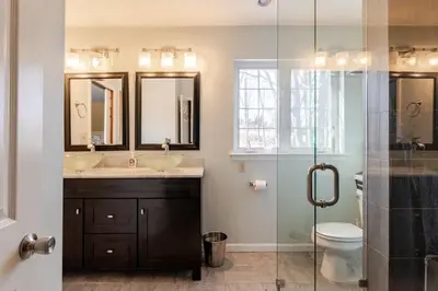 a bathroom with two sinks and a toilet at Mountain View-Steam Shower-2 Tier Patio- King Bed in Northampton