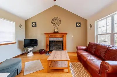a living room with a couch and a table at Mountain View-Steam Shower-2 Tier Patio- King Bed in Northampton