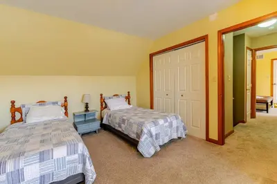 a bedroom with two beds and a sliding door at Mountain View-Steam Shower-2 Tier Patio- King Bed in Northampton