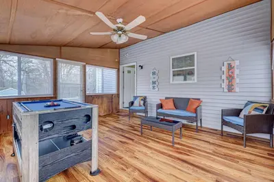 a living room with a ceiling fan and a table at The Gap at Poconos- Sun Room-Arcade- Game Room in Long Pond