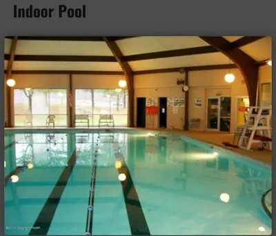 a large swimming pool in a building at The Gap at Poconos- Sun Room-Arcade- Game Room in Long Pond
