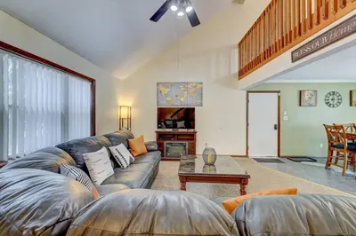 a living room with a couch and a table at The Gap at Poconos- Sun Room-Arcade- Game Room in Long Pond