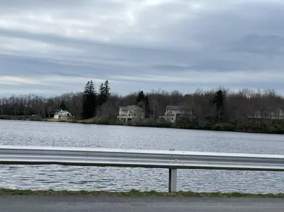 a large body of water with houses in the background at The Gap at Poconos- Sun Room-Arcade- Game Room in Long Pond