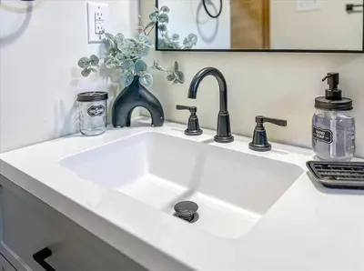 a white sink in a bathroom with a mirror at Rustic Modern Retreat in Poconos in Albrightsville