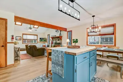 a kitchen with blue cabinets and a living room at Rustic Modern Retreat in Poconos in Albrightsville