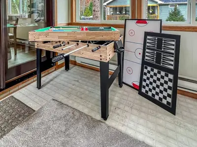 a ping pong table in a living room with a pool table at Rustic Modern Retreat in Poconos in Albrightsville
