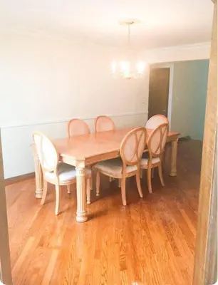 a dining room table with chairs and a wooden floor at 2000 square feet of comfort and relaxation near NYC in South River