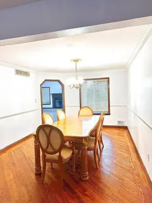 a dining room with a wooden table and chairs at 2000 square feet of comfort and relaxation near NYC in South River