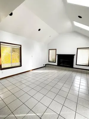 an empty room with three windows and a tiled floor at 2000 square feet of comfort and relaxation near NYC in South River