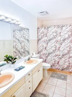 a bathroom with two sinks and a toilet at 2000 square feet of comfort and relaxation near NYC in South River