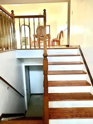 a staircase leading up to a room with a table at 2000 square feet of comfort and relaxation near NYC in South River