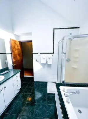 a bathroom with a shower and a sink and a tub at 2000 square feet of comfort and relaxation near NYC in South River