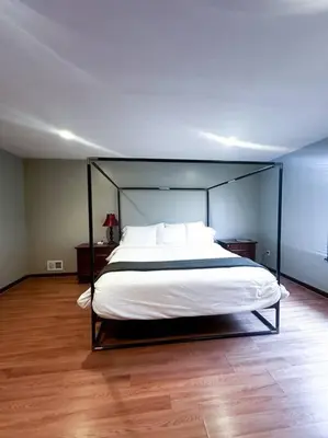 a bedroom with a large bed with a black frame at 2000 square feet of comfort and relaxation near NYC in South River