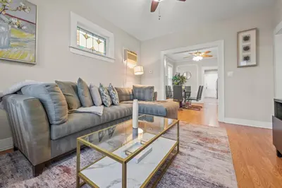 a living room with a couch and a glass table at 2-Story Stay with Game Lounge & Free Parking Spots - 5 mins to NYC Train in Linden