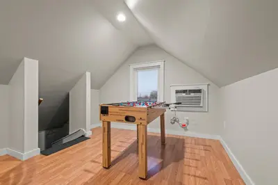 a room with a table in the middle of a room at 2-Story Stay with Game Lounge & Free Parking Spots - 5 mins to NYC Train in Linden