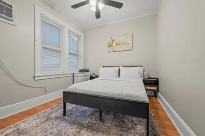 a bedroom with a bed and a ceiling fan at 2-Story Stay with Game Lounge & Free Parking Spots - 5 mins to NYC Train in Linden