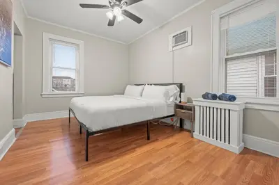 a white bedroom with a bed and a fan at 2-Story Stay with Game Lounge & Free Parking Spots - 5 mins to NYC Train in Linden
